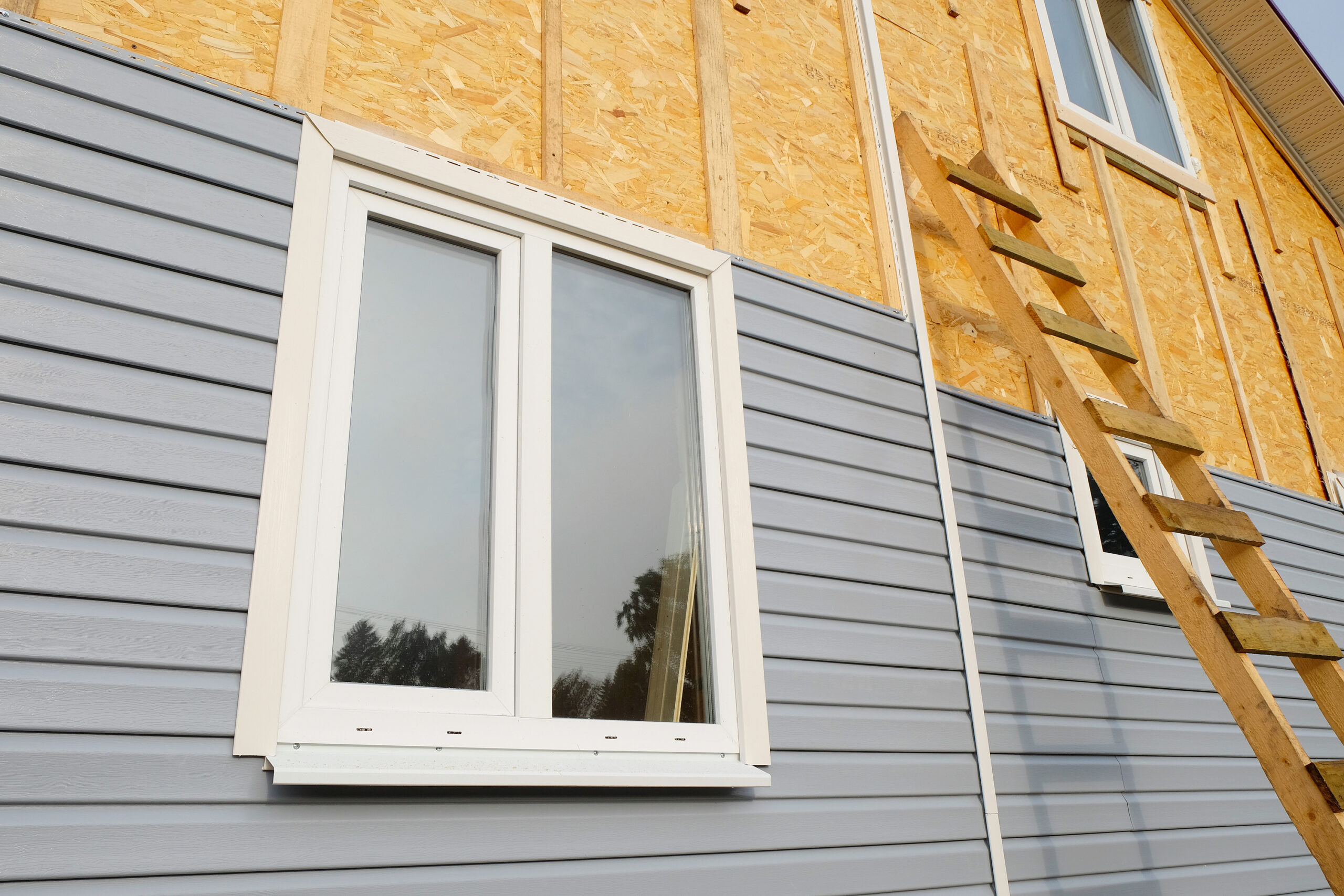 Grey siding, gutters, and soffit on a new home